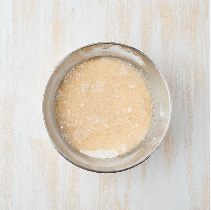 Pour in the cold water into the dry mix