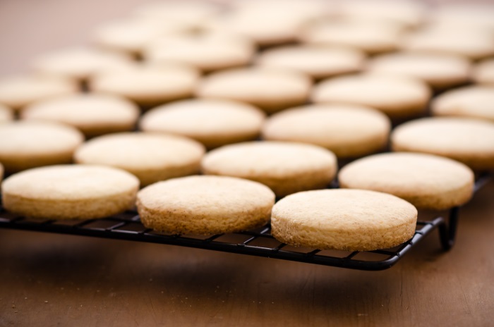 pale baked alfajores on a tray