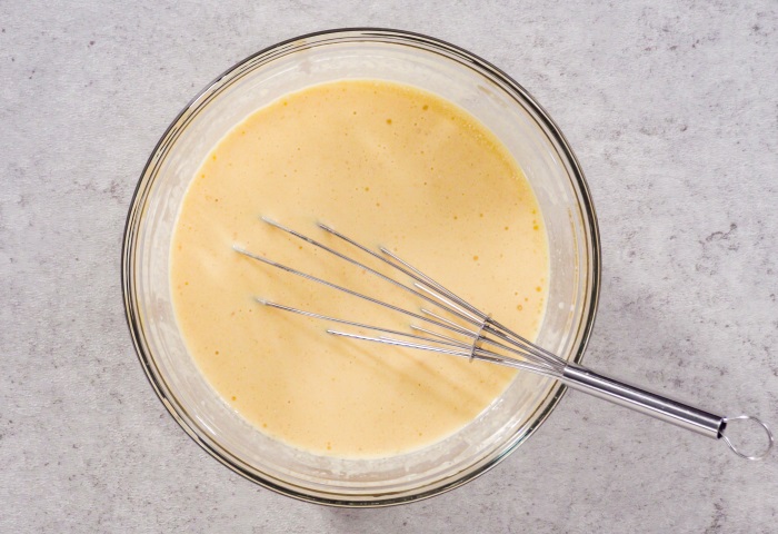 smooth crepe batter resting in bowl to make banana nutella crepe rolls